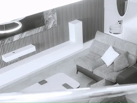 View down to the gray sofa, coffee table and wall-mounted entertainment unit