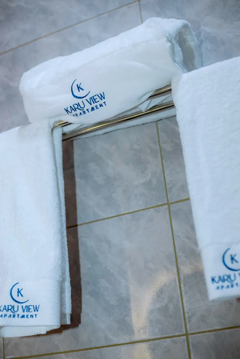 White towels embroidered with the Karu View Apartment logo