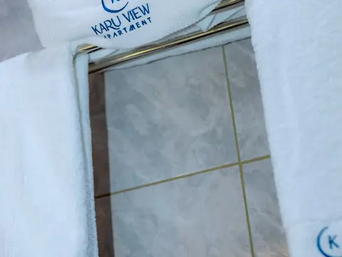 White towels embroidered with the Karu View Apartment logo